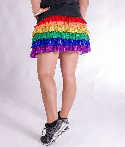 Rear view of Model wearing Ruffle Sparkle Skirt with Red Orange Yellow Green Blue Purple Tiers