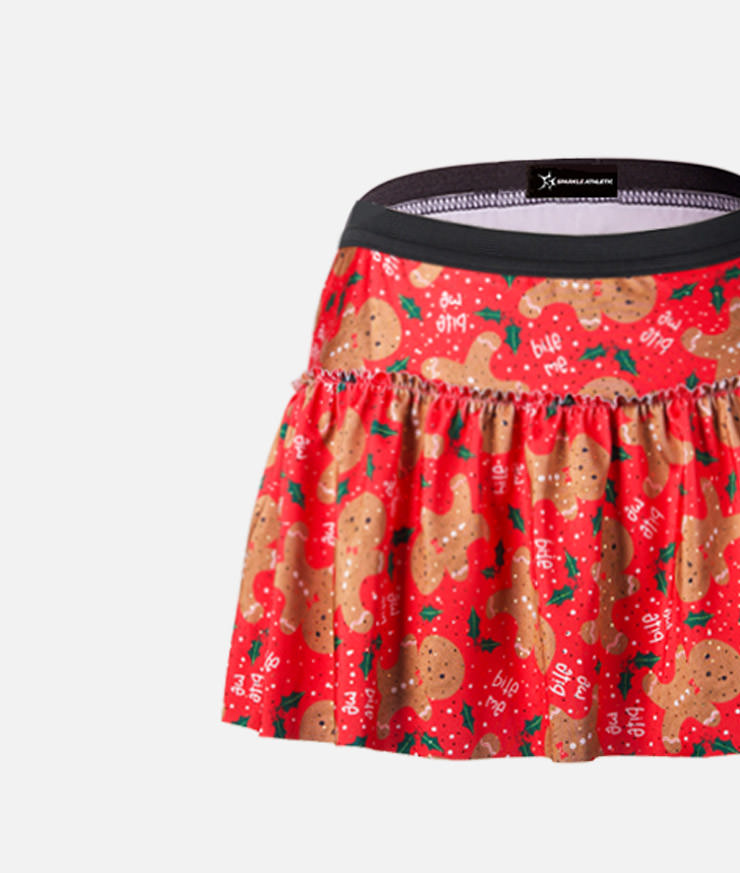 gingerbread cookies on red background running skirt with green mistletoe