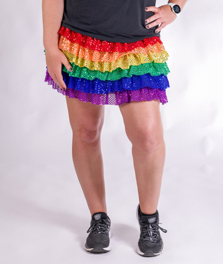Model wearing Ruffle Sparkle Skirt with Red Orange Yellow Green Blue Purple Tiers